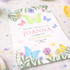 butterfly birthday invitation card with floral design on party table