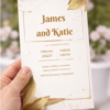 elegant wedding invitation with gold leaf design close up