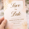 elegant wedding save the date card with gold floral line art close up
