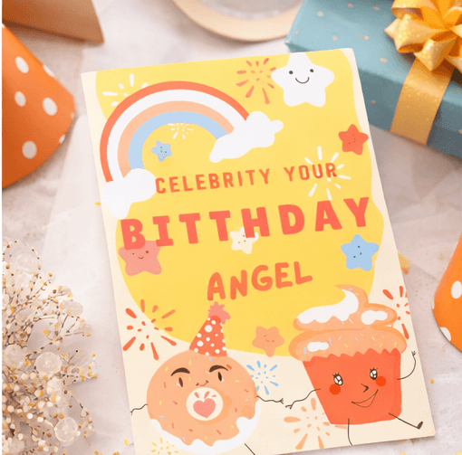 kids birthday invitation with rainbow and cupcake design close up